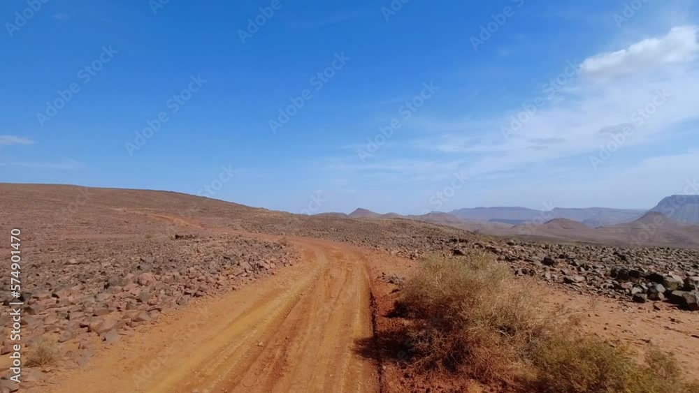 Point of view driving fast on a dirt road surrounded by millions of stones Point of view driving fast on a dirt road surrounded by millions of stones