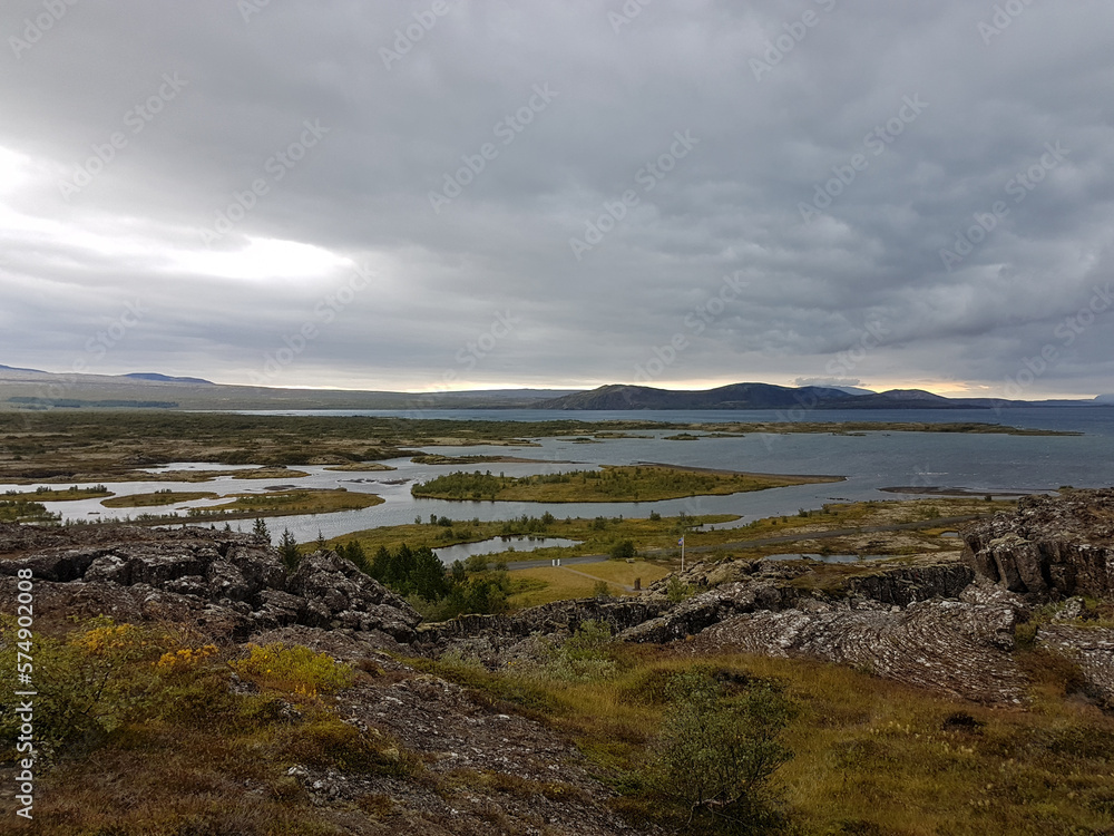 Lake view with mountains in the horizon on a cloudy day at Thingvellir National Park in Iceland