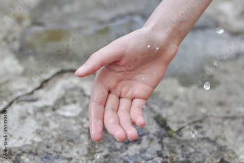 Hand and drops of water. Pour water on your hand.  © Live heavenly