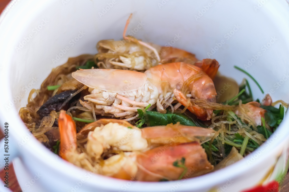 Steamed Prawns with Vermicelli in white hot pot Thai food background Steamed Prawns with Vermicelli in white hot pot Thai food background