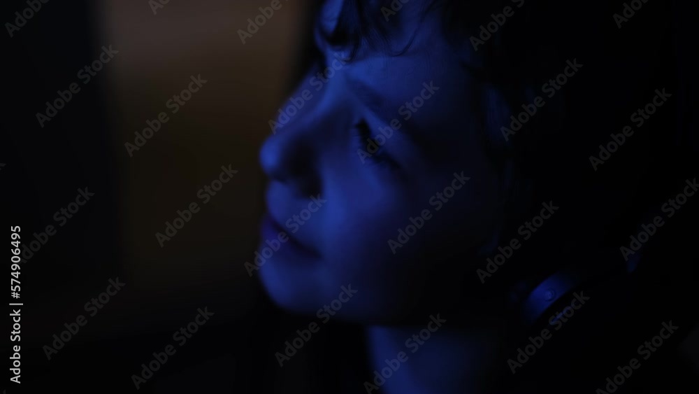 Child eye close-up tablet screen display. Monitor blue light is reflected in her eyes. effects on the eyes. reflection light on TV.