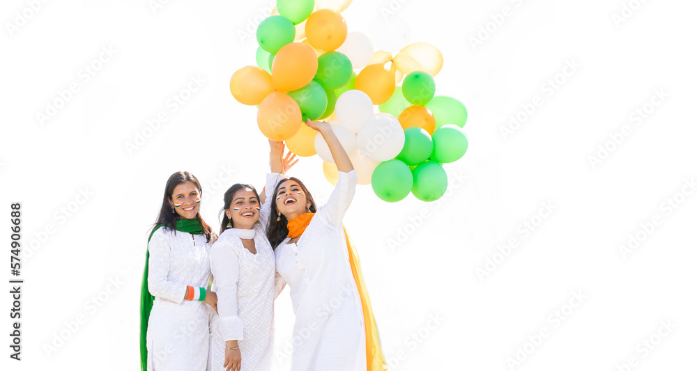 Group of beautiful happy young indian women wearing traditional white kurta dress holding tricolor balloons isolated on white background, celebrating independence day or republic day concept. Group of beautiful happy young indian women wearing traditional white kurta dress holding tricolor balloons isolated on white background, celebrating independence day or republic day concept.