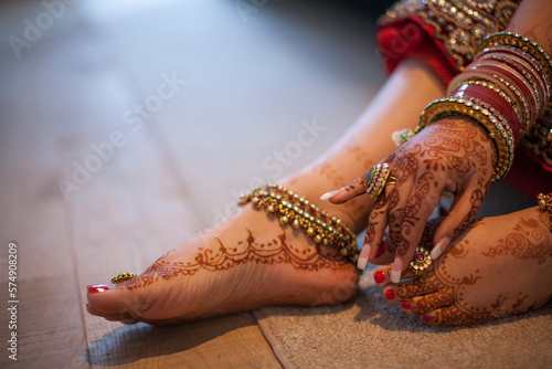 Jewelry is worn over the henna covered hands and feet of an Indian woman. photo