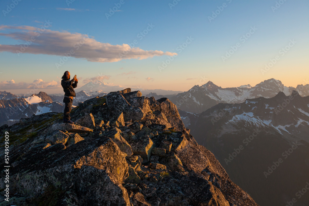 Mountaineer photographing view at sunset in North Cascade Mountain Range, Chilliwack, British Columbia, Canada Mountaineer photographing view at sunset in North Cascade Mountain Range, Chilliwack, British Columbia, Canada