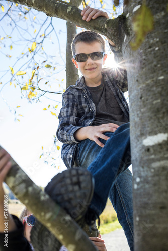 Young man climbing tree. photo