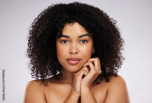Beauty, skincare and portrait of a black woman with cosmetics isolated on a grey studio background. Serious, young and face of a model with a fresh afro, cosmetology and elegant on a backdrop