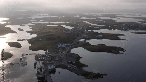 Golden hour drone shot of Lochmaddy, showing the Lochmaddy to Uig ferry run by Caledonian Macbrayne. Filmed on North Uist in the Outer Hebrides of Scotland. photo