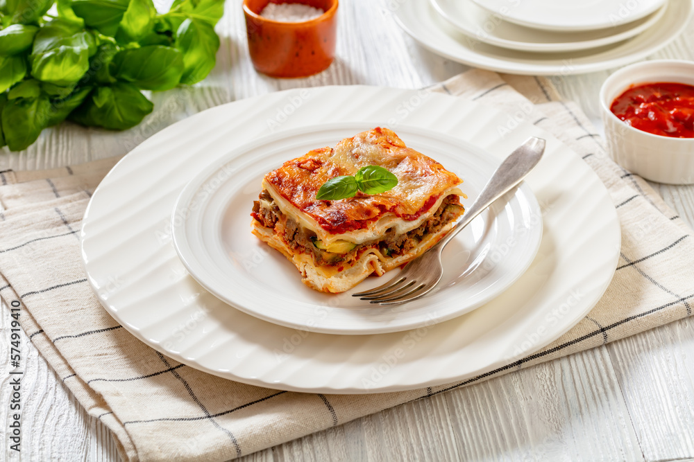 portion of Lasagna on white plate, top view portion of Lasagna on white plate, top view