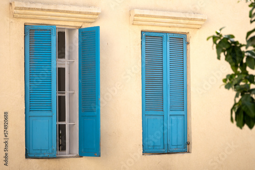 Vintage blue wooden shutters on a windows of a house