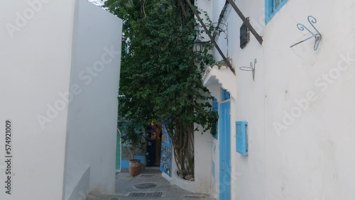 Pan Down View Along Narrow Quaint Street In Tangier Of Building With Bright Blue Door And Window Frame