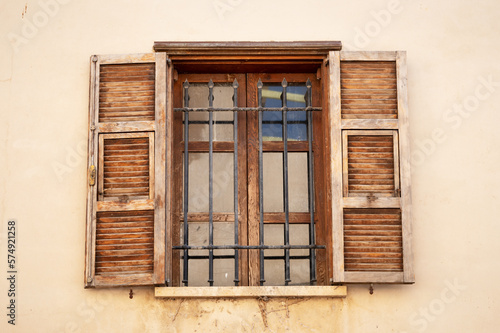 Vintage opened brown wooden shutters on a window