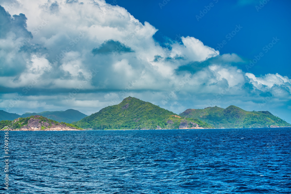 Mountains and vegetation of a beautiful tropical island as seen from the ocean Mountains and vegetation of a beautiful tropical island as seen from the ocean