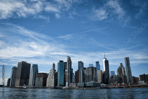 Lower Manhattan and New York Harbor on a sunny day with blue skies