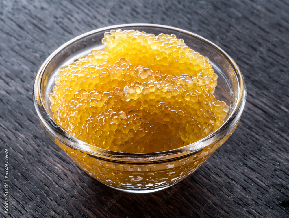 Pike caviar or roe in the bowl on wooden background. Pike caviar or roe in the bowl on wooden background.