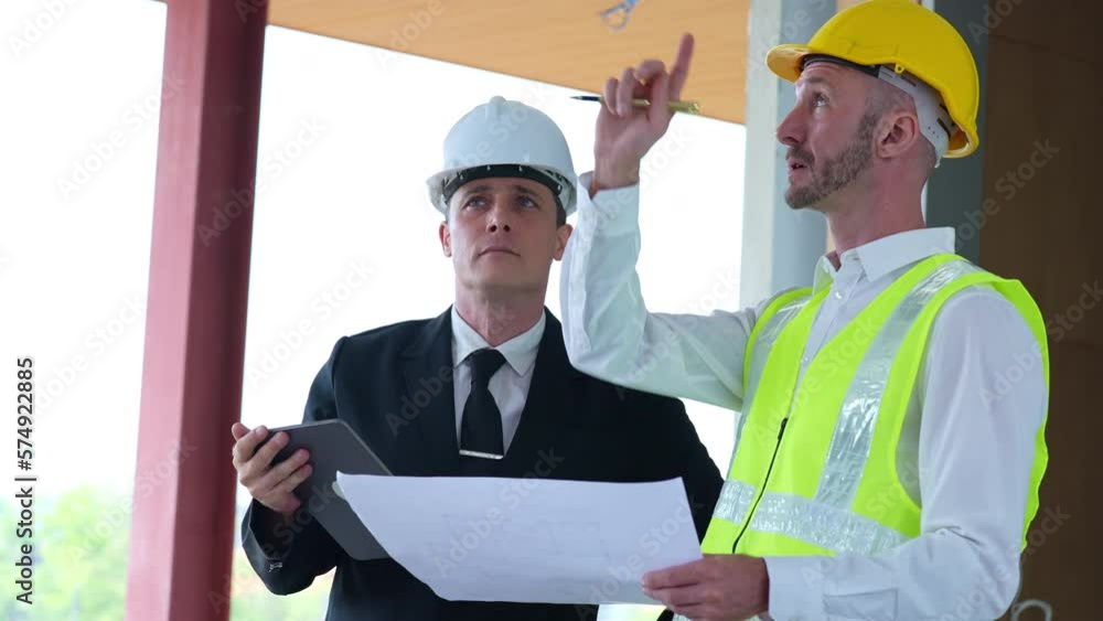A team of engineers is discussing the structure to validate the building under construction. A team of engineers is discussing the structure to validate the building under construction.