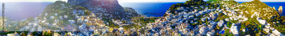 Faraglioni from Capri Town in Capri, Italy. Aerial view from drone at summer sunset
