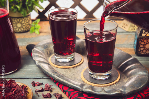 Fototapeta Naklejka Na Ścianę i Meble -  Arabic Cuisine; Middle Eastern popular hibiscus drink or (Karkadeh). It is traditional Arabic drink served during the holy month of Ramadan. It is a sweet infusion made from hibiscus flower.