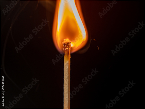 Burning match on a black background. Flame from a lit match. Close-up.
