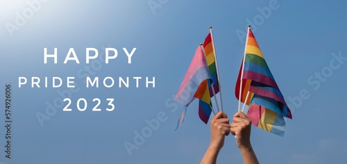 HAPPY PRiDE MONTH 2023' on bluesky with LGBTQ+ flags and rainbow flag, symbol of LGBT, background, concept for LGBTQ+ celebrations and respecting gender diversity, in pride month, June, 2023.