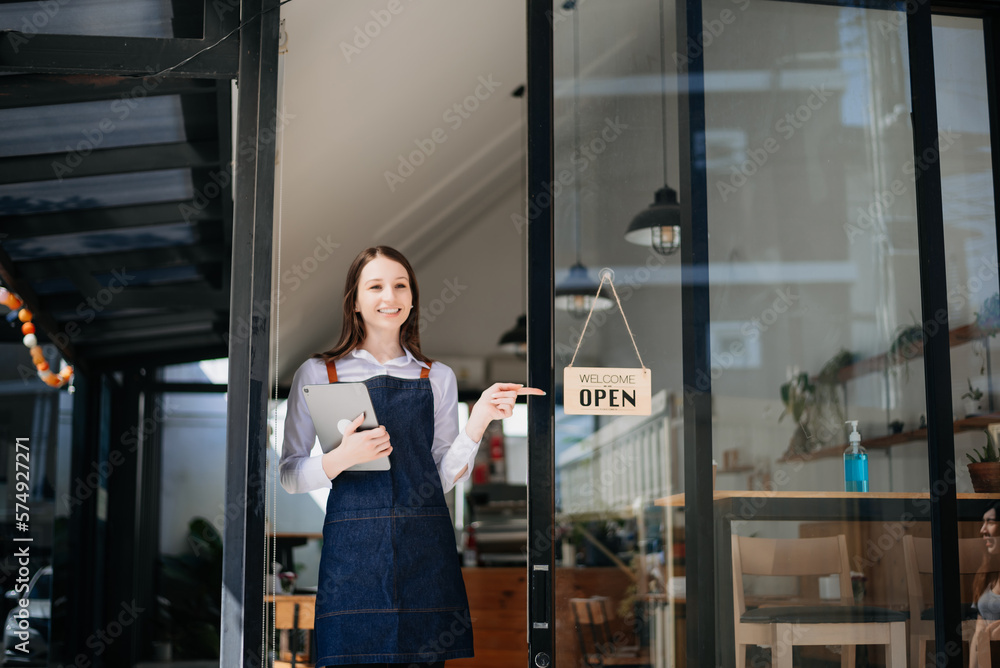Woman coffee shop owner holding notepad and digital tablet ready to receive orders. in cafe restaurant. woman barista cafe . Woman coffee shop owner holding notepad and digital tablet ready to receive orders. in cafe restaurant. woman barista cafe .