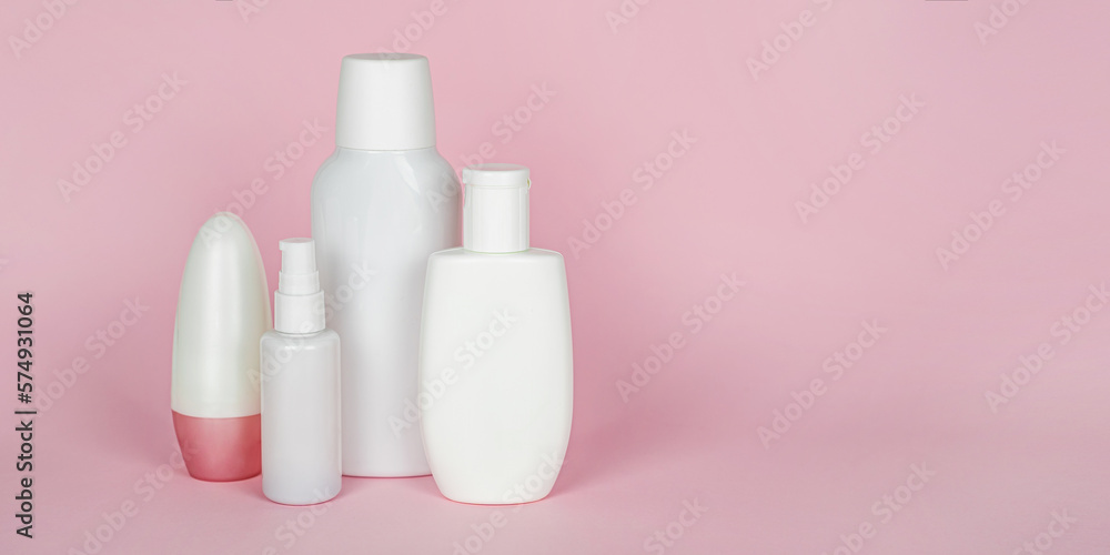 A set of items for selfcare and hygiene: shampoo, conditioner, body cream, antiperspirant, deodorant on a pink background. Banner, mock-up, copy space for text A set of items for selfcare and hygiene: shampoo, conditioner, body cream, antiperspirant, deodorant on a pink background. Banner, mock-up, copy space for text
