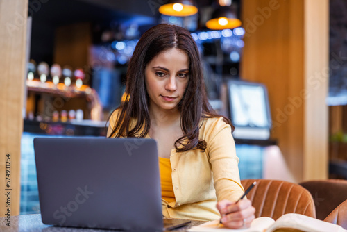 Portrait of an attractive young woman using laptop in cafe
