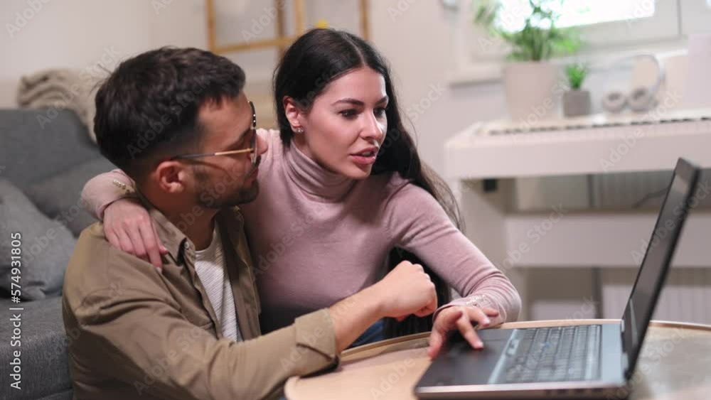 Young couple relaxing on sofa with laptop.Love,happiness,people and fun concept. Young couple relaxing on sofa with laptop.Love,happiness,people and fun concept.