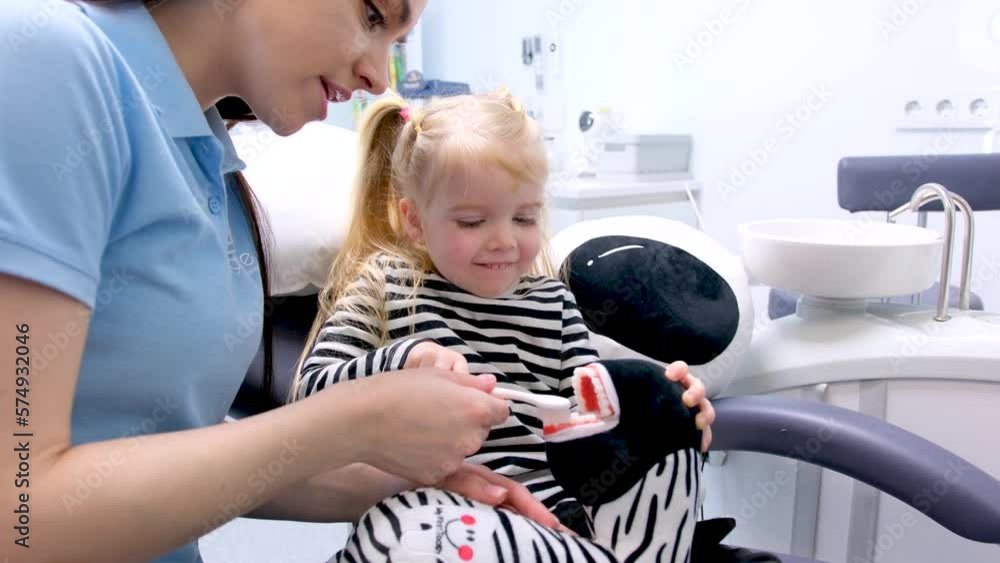 dentistry for first time brushing teeth lesson little girl in striped