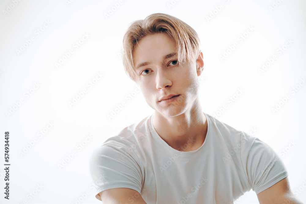 austere and deadpan man look unsmiling at camera with pensive and serious thoughts while stand isolated on white with focused and earnest facial expression austere and deadpan man look unsmiling at camera with pensive and serious thoughts while stand isolated on white with focused and earnest facial expression