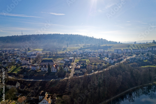 Scenic view of village of Feuerthalen with Cholfirst communications tower in the background on a sunny winter day. Photo taken February 16th, 2023, Schaffhausen, Switzerland.