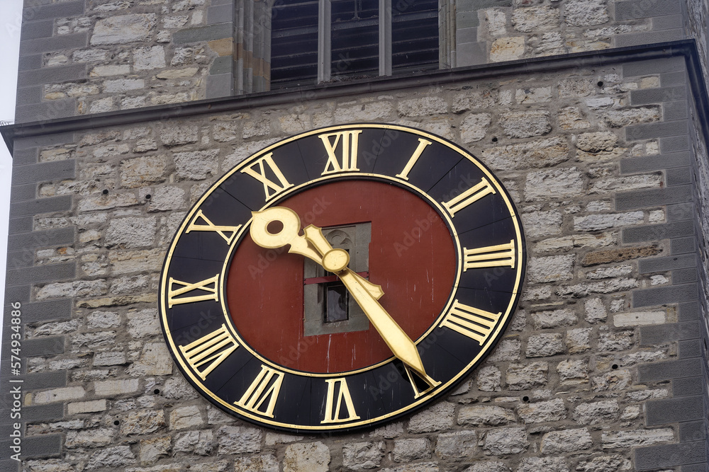 Close-up of stone church tower of church St. Johann with clock face at the old town of Swiss City of Schaffhausen on a foggy winter day. Photo taken February 16th, 2023, Schaffhausen, Switzerland.