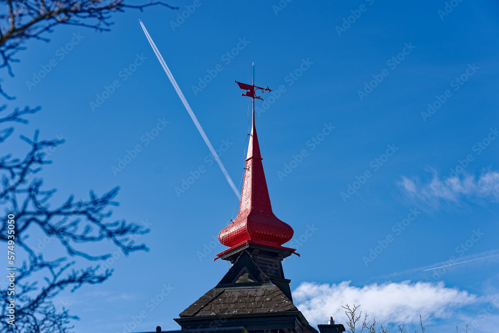 Red spire of residential house with wind vane at City of Schaffhausen on a sunny winter day. Photo taken February 16th, 2023, Schaffhausen, Switzerland. - obrazy, fototapety, plakaty 