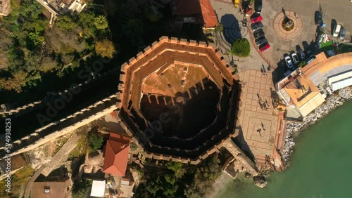 Top view from circling copter moving up at beautiful old city Alanya overwashed by Mediterranean sea in Altanya Province, Turkey. Summer time, slow motion, 4k. Panorama view. photo