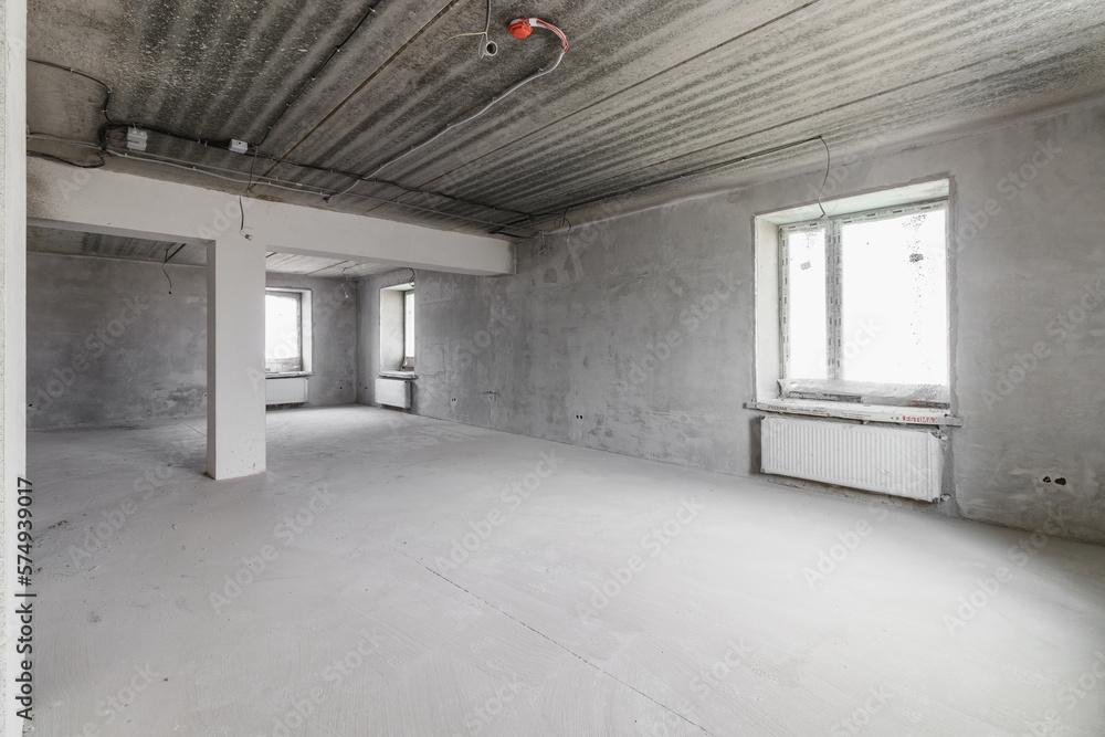 Spacious empty rooms floor after filling out the work on the wall and ceiling Spacious empty rooms floor after filling out the work on the wall and ceiling