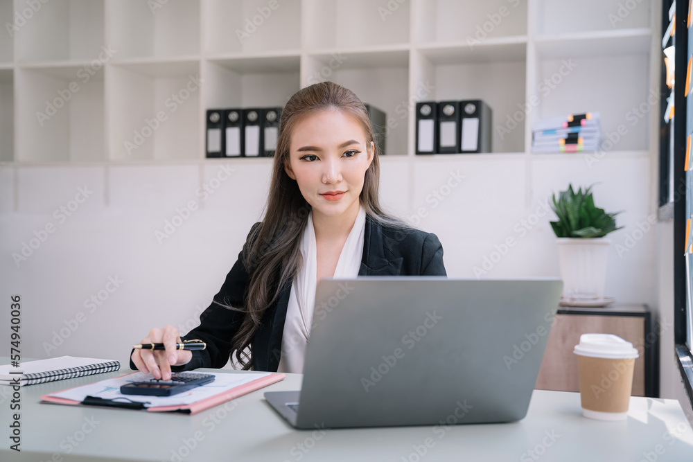Business women calculate and analyzing graph document financial with laptop. Business women calculate and analyzing graph document financial with laptop.
