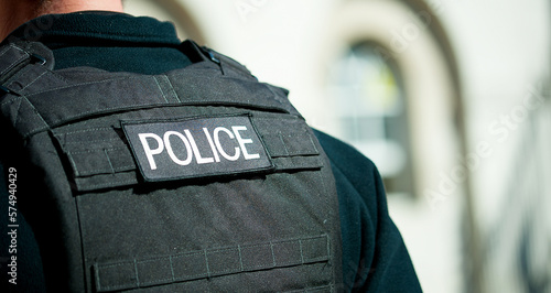 Whitehall, London, UK. 16th July 2016. Police logo patch, being worn on the rear of a bullet proof vest by a Metropolitan police officer in central London, UK.