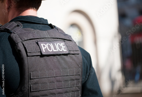 Whitehall, London, UK. 16th July 2016. Police logo patch, being worn on the rear of a bullet proof vest by a Metropolitan police officer in central London, UK.