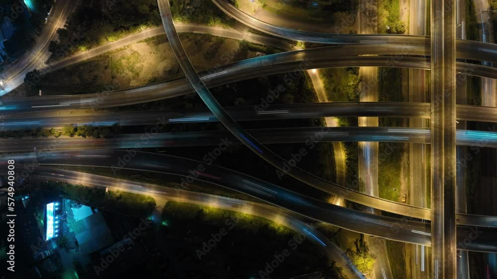 Hyperlapse time-lapse of car traffic transportation above circle roundabout road in Asian city. Drone aerial view fly in circle, high angle. Public transport or commuter city life concept Hyperlapse time-lapse of car traffic transportation above circle roundabout road in Asian city. Drone aerial view fly in circle, high angle. Public transport or commuter city life concept
