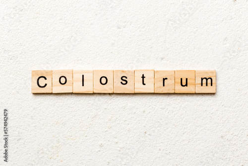 colostrum word written on wood block. colostrum text on table, concept photo