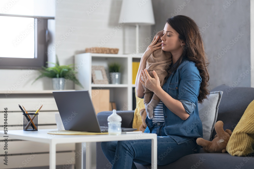 A young new mom is concerned about her baby's health, looking for doctors' advice online. Telemedicine. Оnline counseling with a pediatrician A young new mom is concerned about her baby's health, looking for doctors' advice online. Telemedicine. Оnline counseling with a pediatrician