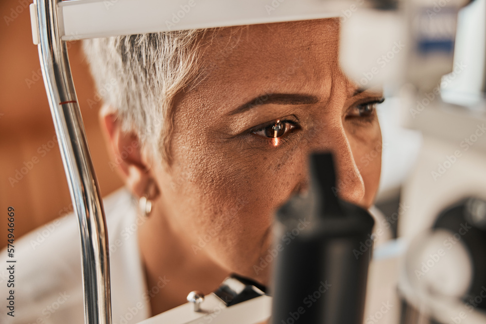 Laser, vision or senior customer in eye exam for eyesight at optometrist office in assessment or consultation. Face of mature woman testing or checking vision to help iris or retina visual health - obrazy, fototapety, plakaty 