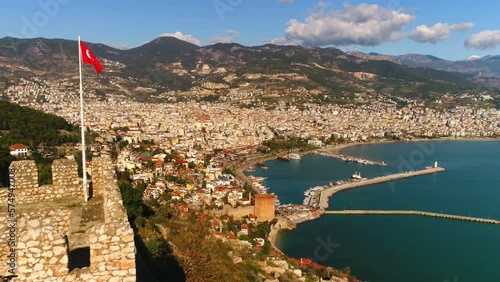 Beautiful panorama view of sunny Alanya town in Altanya Province, Turkey. Flying copter over city overwashed by Mediterranean sea. photo