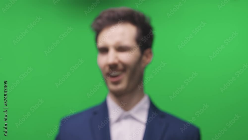 Showman in a suit, holding and showing a smartphone with a photo of himself, chromakey template, portrait. Showman in a suit, holding and showing a smartphone with a photo of himself, chromakey template, portrait.