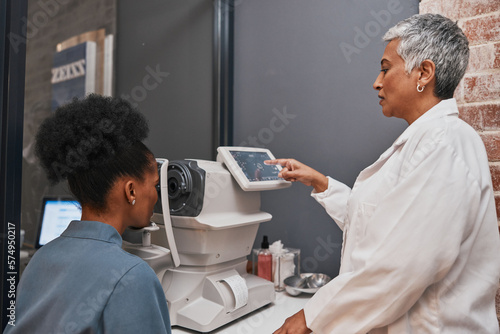 Digital eye exam, vision and health for eyes, optometry and doctor with patient, eyecare and ophthalmology clinic. Machine, screen and black woman with senior optometrist, service and medical exam