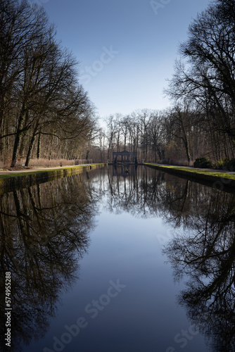 View of the Reflection Pool in 'Het Stad's' Park, in Aalst, East Flanders, Belgium. Beautiful reflections of the surrounding trees in the still water during the winter. With copy space.