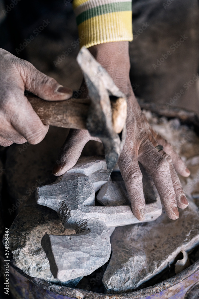 Faceless stonemason creating stone sculpture Faceless stonemason creating stone sculpture