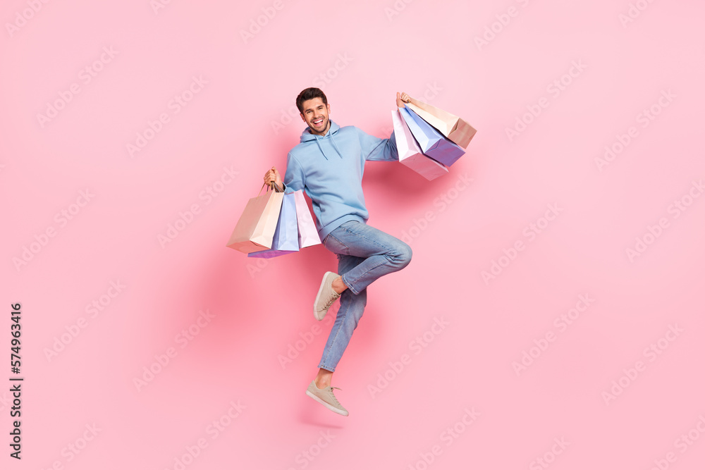 Full length photo of glad man client customer wear trendy blue clothes hold bags rejoice nice purchases isolated on pink color background - obrazy, fototapety, plakaty 