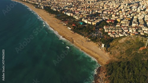 Flying copter to beautiful sunny beach with people in Alanya town overwashed by Mediterranean sea. Antalya Province in Turkey. photo