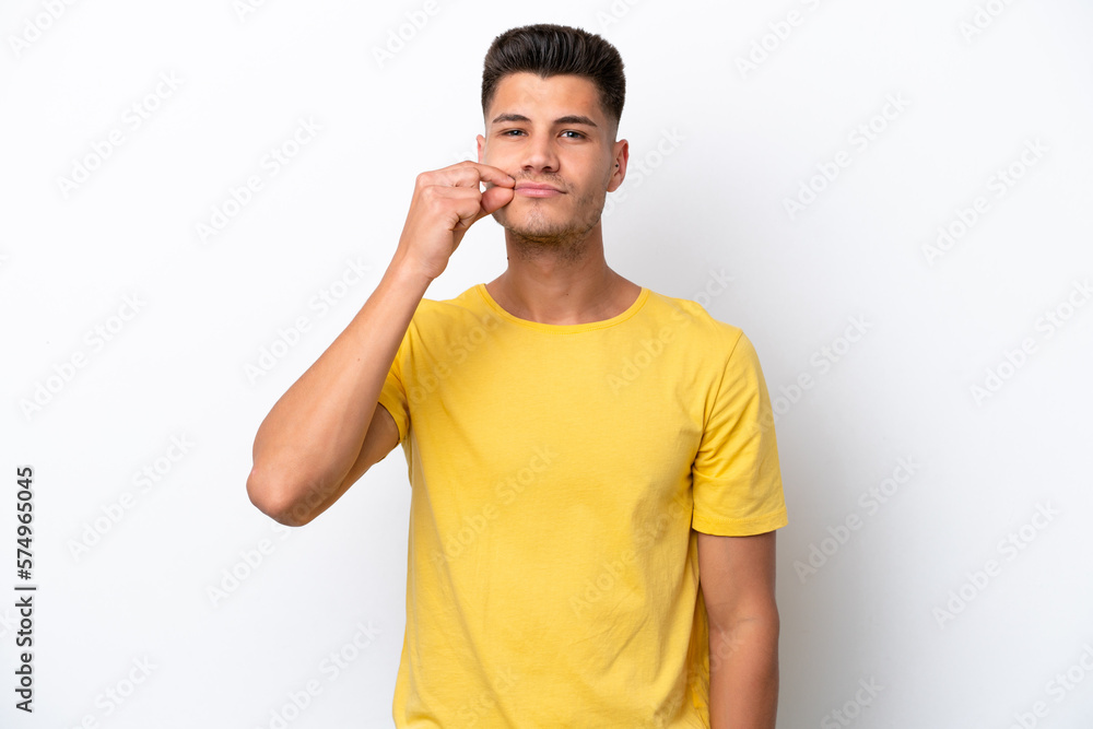 Young caucasian man isolated on white background showing a sign of silence gesture Young caucasian man isolated on white background showing a sign of silence gesture