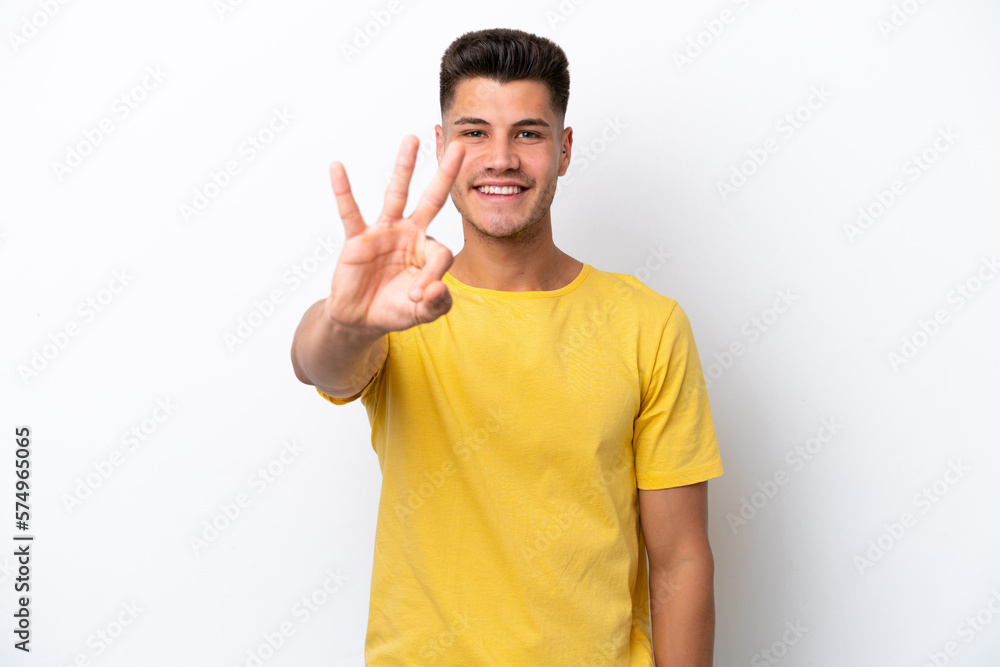 Young caucasian man isolated on white background happy and counting three with fingers Young caucasian man isolated on white background happy and counting three with fingers